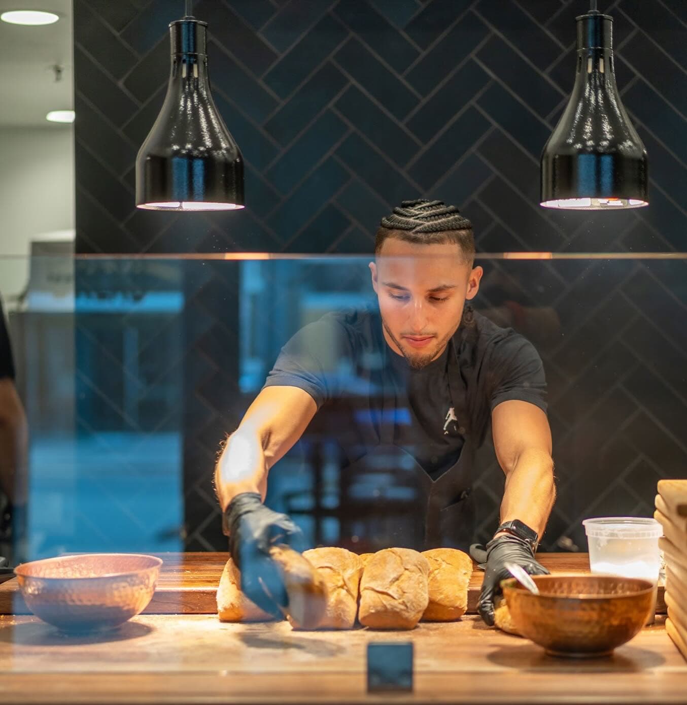 Chef D preparing fresh bread in his kitchen
